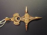 a gold scissors that is on top of a black table