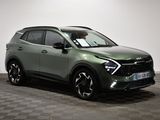 the green suv is parked in a room with checkered floor