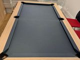 a pool table with a blue cloth on top of it