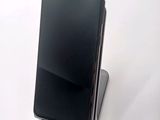 a cell phone that is sitting on top of a stand