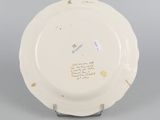 underside view of a porcelain plate with writing on it