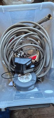 a box with hoses and a water pump in it