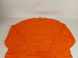 an orange shirt sitting on top of a white table