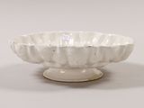 a white bowl sitting on top of a white table