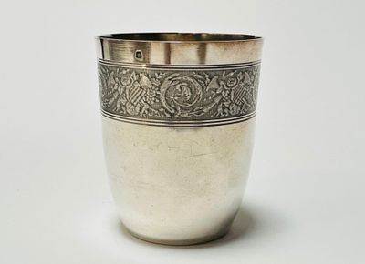 a silver cup that is sitting on a table