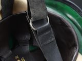 a green and black bag with a hat on it