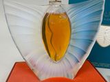 a glass sculpture of a yellow and blue butterfly on top of a red box