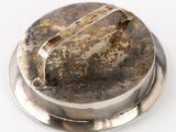 a close up of a metal object on a white surface