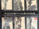 a black binder with a bunch of old photos on it