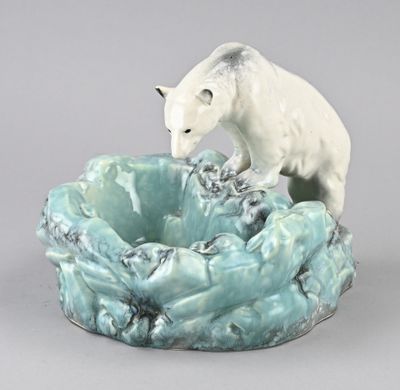 porcelain figurine of a polar bear on top of a blue bowl