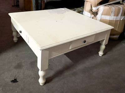 a white table with a drawer on it in a room