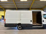 a white van with its doors open in a warehouse