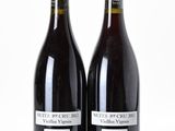 two bottles of wine sitting next to each other on a table