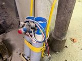 a cat that is standing next to a gas can