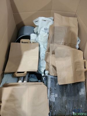 a cardboard box filled with bags and other items
