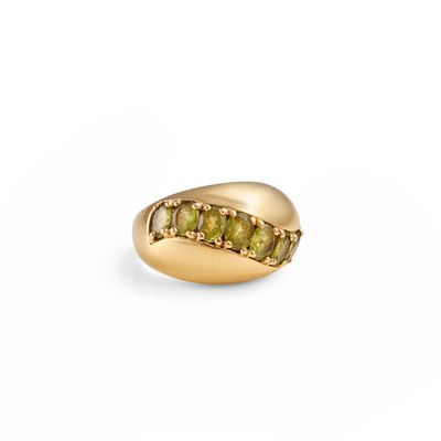 a close up of a gold ring with green stones