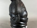 a close up of a sculpture of a head on a stand