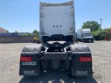 the back end of a white truck parked in a parking lot