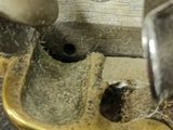a person that is using a hammer to fix a piece of metal