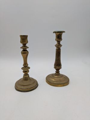 pair of antique brass candlesticks on a white background