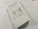 a white table cloth with a red design on it