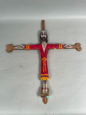 cross made of wood with a man on it on a white surface