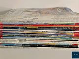a lot of books stacked on top of each other on a table