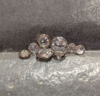 a close up of a bunch of crystal stones on a surface