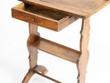 an old wooden desk with a drawer on top of it