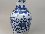blue and white vase with a floral design on the outside