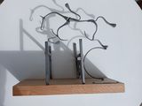 a sculpture of scissors on a shelf on a table