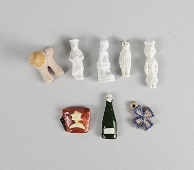 a small assortment of miniature figurines including a bottle of wine and a teddy bear