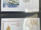 two envelopes with a picture of a ship on them on a table