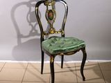 a chair that has a green seat on it