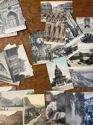 many old postcards on the table with pictures of buildings