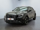 a grey audi suv parked in a large room with a black floor
