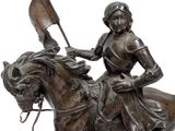 statue of a man riding a horse with a flag on its back