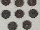 nine buttons arranged in a circle on a white surface