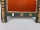 a small green and gold cabinet with a mirror on it