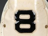 a white and black baseball hat with the number 8 on it