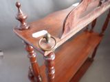 a wooden shelf with a mirror on top of it