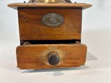 a small wooden box with a brass bell on top