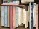 a box full of books that are stacked on top of each other