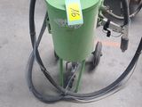 a green machine that is sitting on the ground