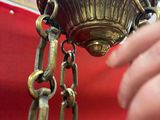a woman that is holding a chandelier in her hand