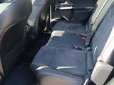 the back seats of a car are black with red stitching
