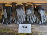 four pairs of gloves are on display in a display case