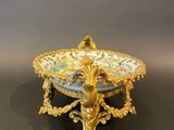 a close up of a bowl on a stand on a table