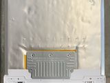 an overhead view of a metal box with a metal cover on it