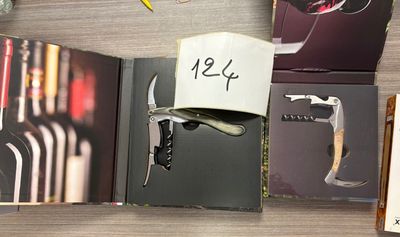 a wine bottle and a cork opener on a table